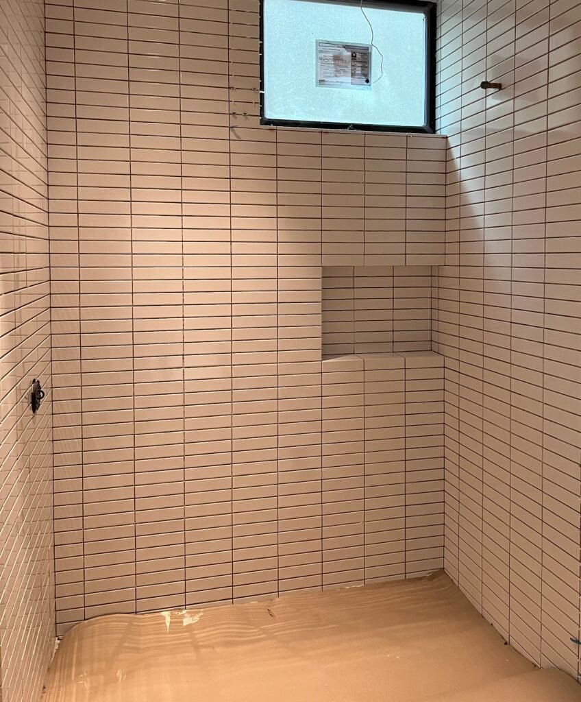 Modern shower tile installation with wall niche